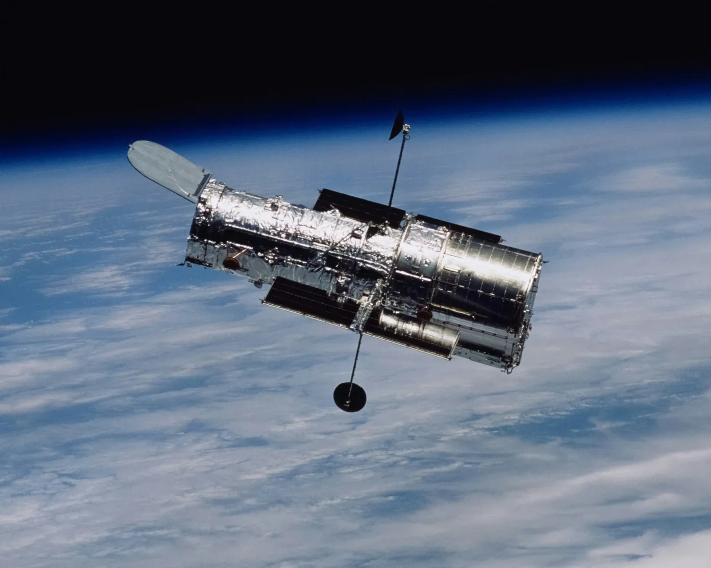 A space telescope in orbit above the Earth